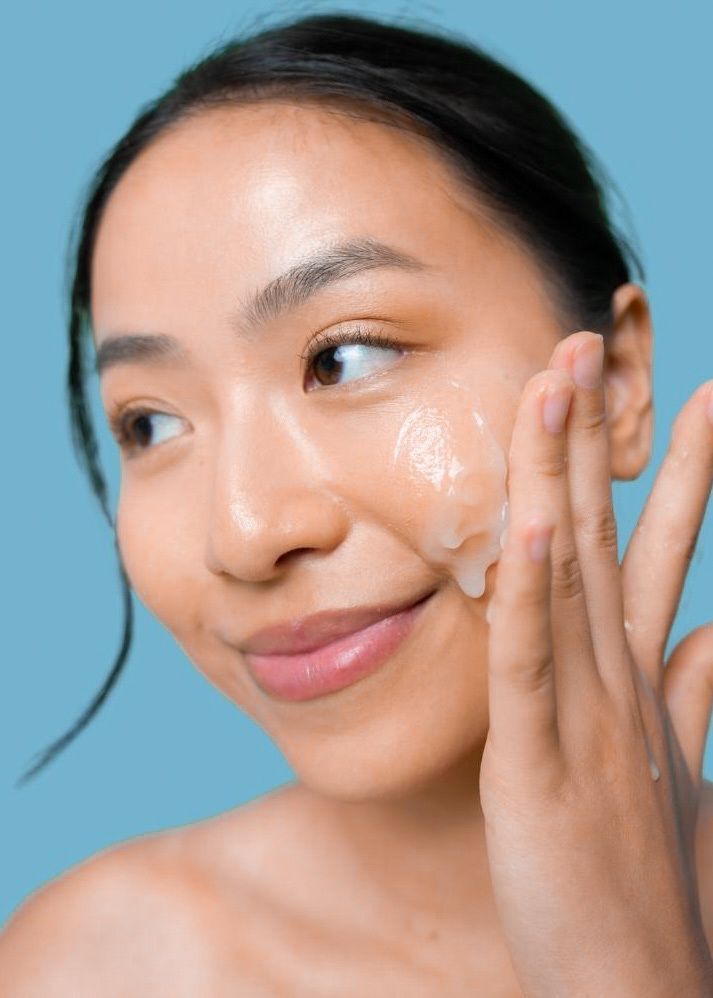 Tallow cleanser being massaged onto a cheek